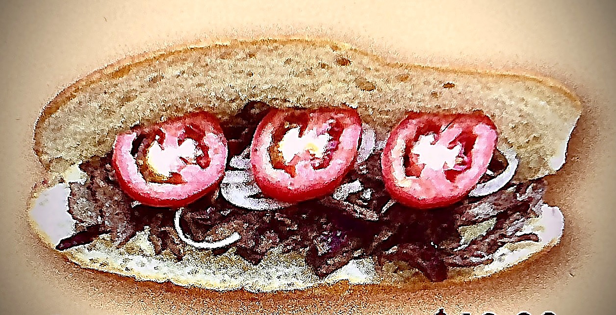 Shawourma french roll with sliced beef, onion and tomato