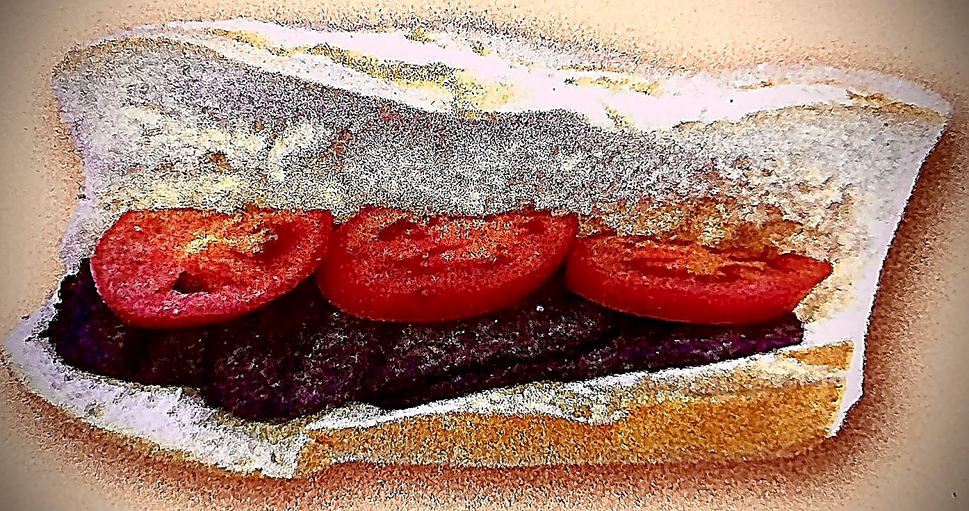 Soujouk Armenian sausage sandwich with tomato slices on french roll
