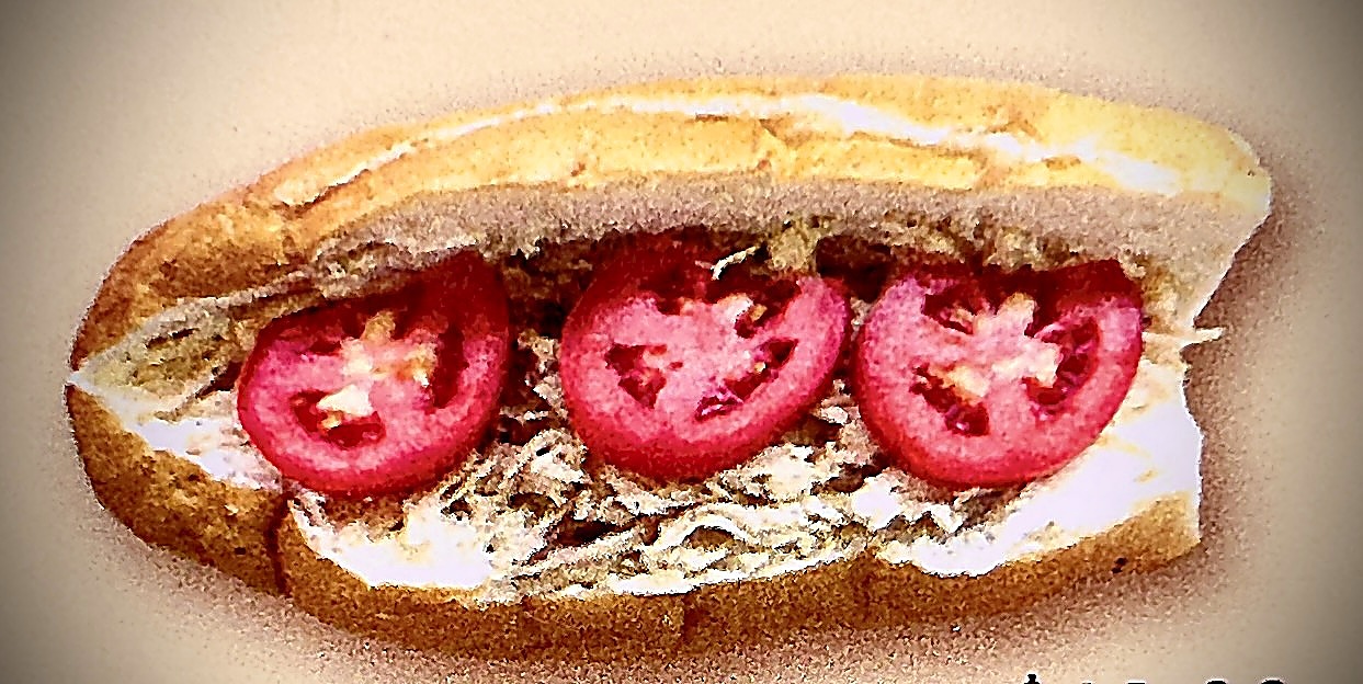 Chicken with garlic sauce french roll topped with tomato slices