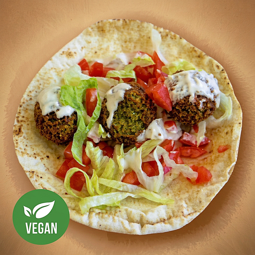 Falafel pita sandwich with tahini and vegetables