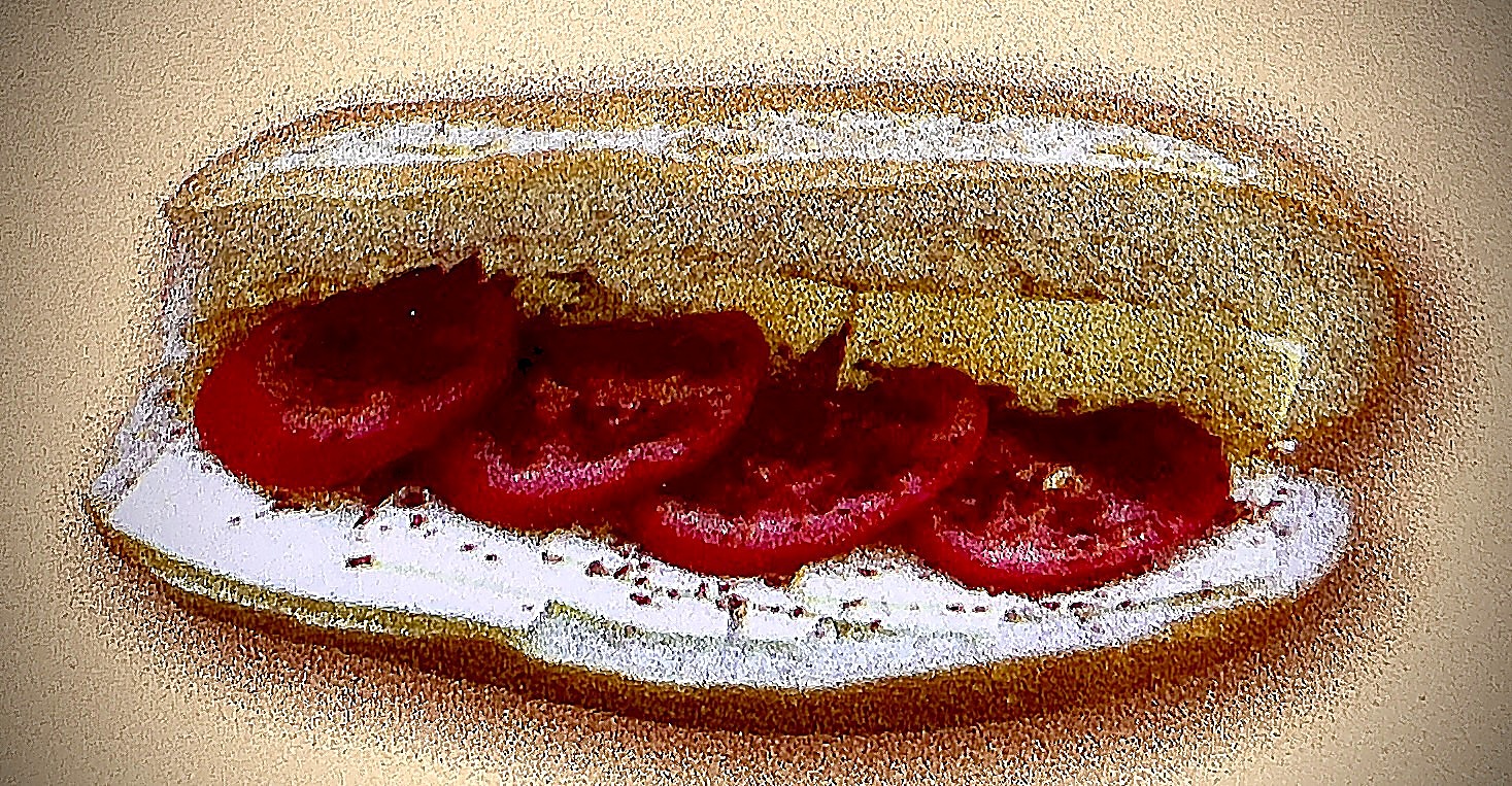 Melted swiss cheese sandwich with tomato slices on french roll